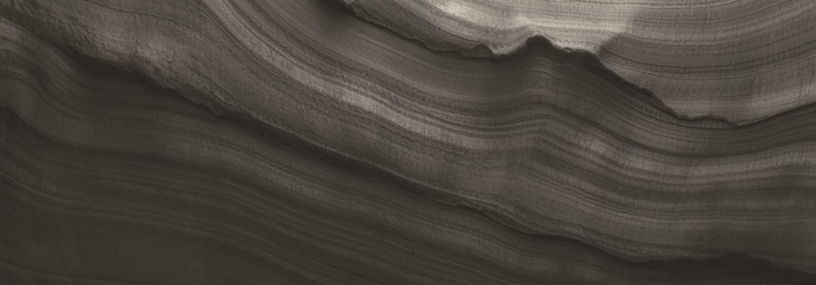 Stone & Pillar strata artwork, plate 21: layered rock in warm stone, the colour this site uses for planning & development matters.